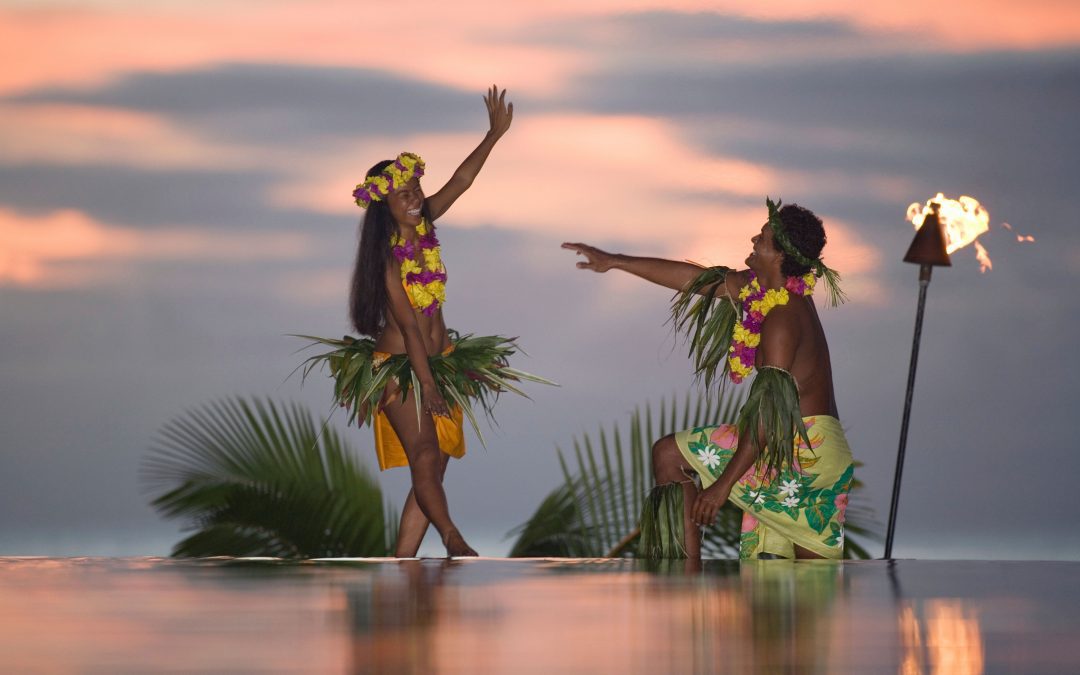 two dancers performing at twilight with a vibrant